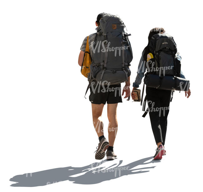 two cut out backlit hikers walking