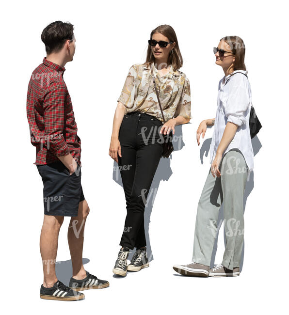 man talking to two girls standing and leaning on a railing