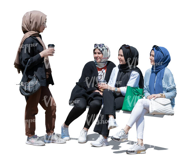 four muslim girls sitting and chatting