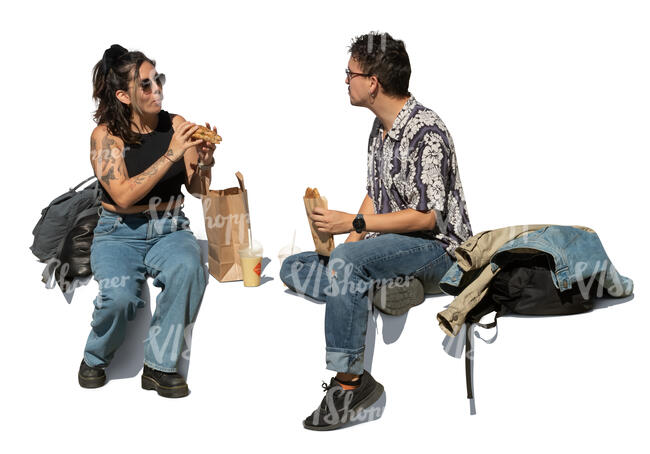 man and woman sitting and eating lunch outside on the street