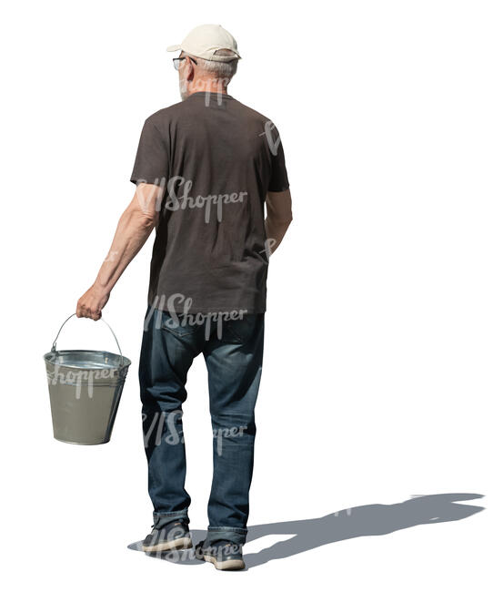 older man with a bucket walking in the garden
