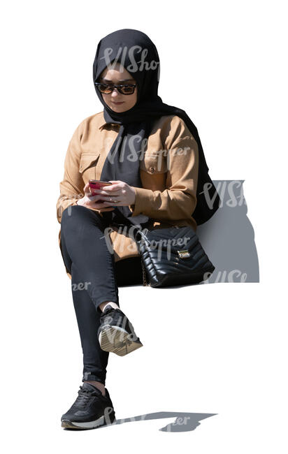 cut out muslim woman sitting and texting