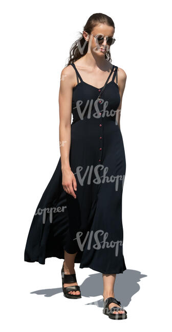 cut out woman in a long black summer dress walking