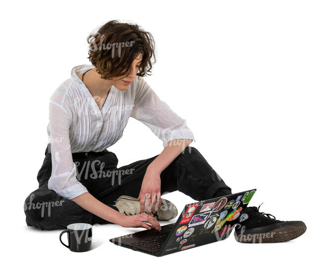 young woman sitting on the ground and working with laptop