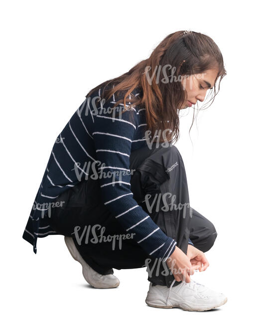 woman squatting and tying her shoe laces