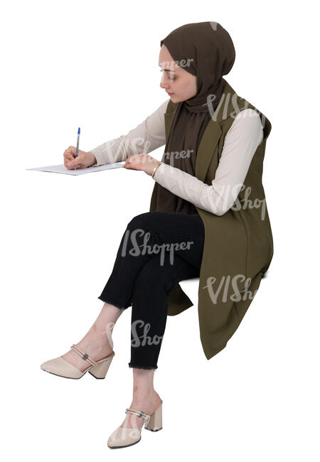 cut out muslim woman sitting at a desk and writing