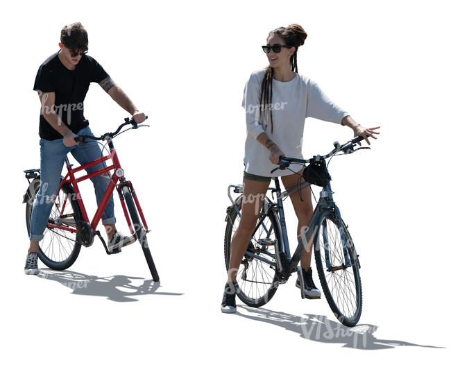 two cut out backlit people with bikes standing ready to start riding 