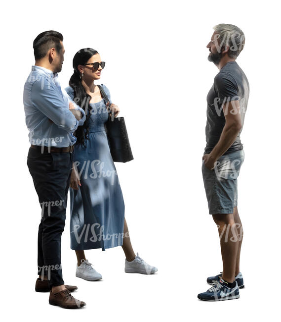 three people staning in partial light and talking