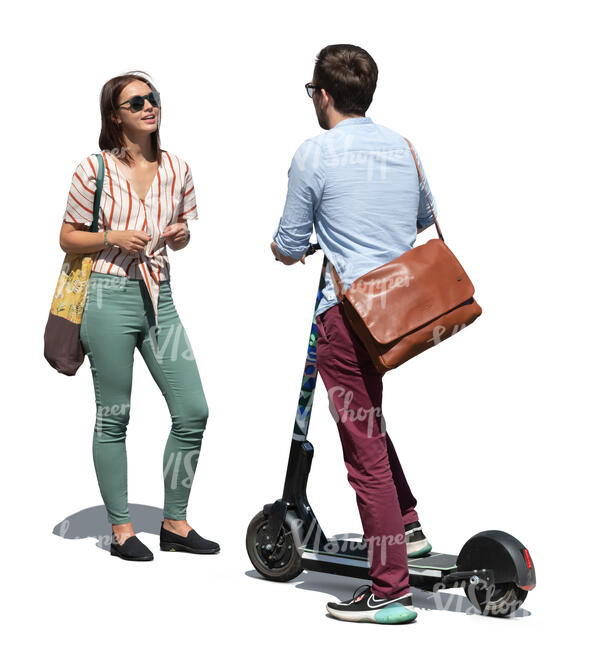 man with a scooter standing and talking to a woman on the street