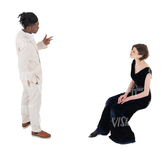 top angle view of a man in a white suit talking to a woman in black sitting