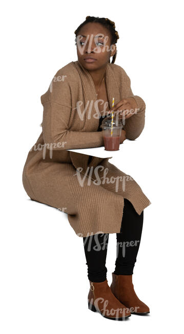 woman sitting and drinking juice and looking around
