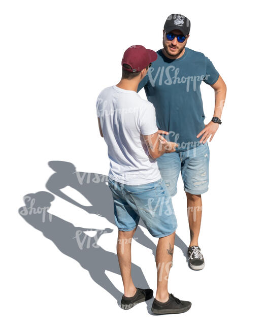 two men with baseball caps standing and talking