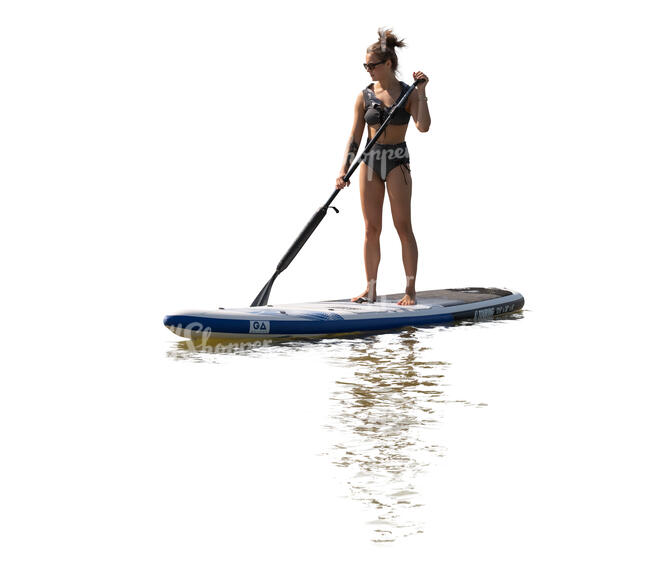 cut out backlit woman paddleboarding