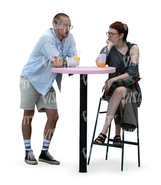 man and woman sitting at a bar table and drinking