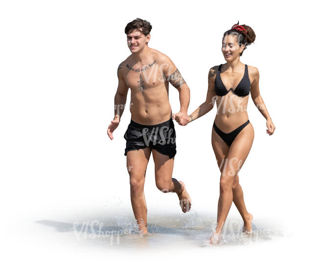 couple running happily along the beach