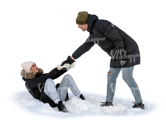 man pulling up a woman sitting in the snow