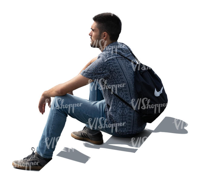 backlit man sitting on the stairs