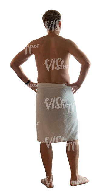 man in a sauna towel standing and looking out of the window