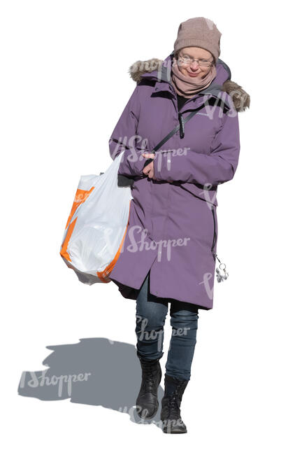 woman with a big bag of groceries walking in winter
