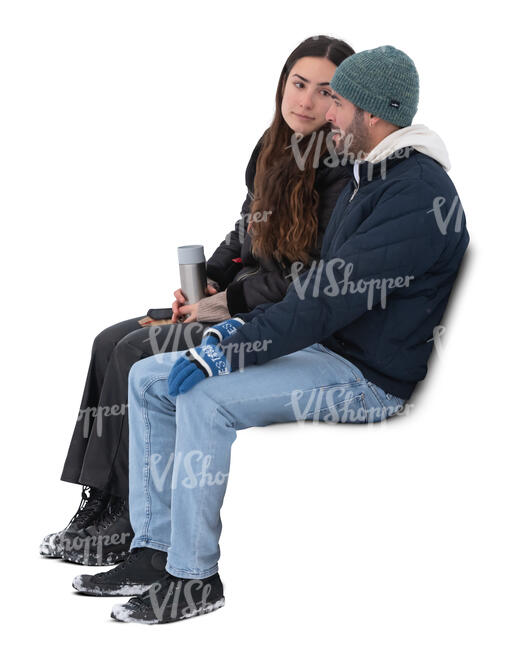two cut out people sitting outside in winter and drinking hot tea