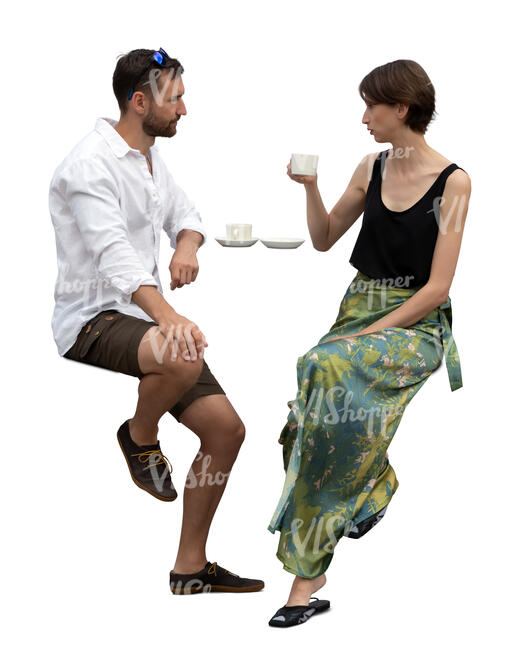 man and woman sitting at a bar table and drinking coffee