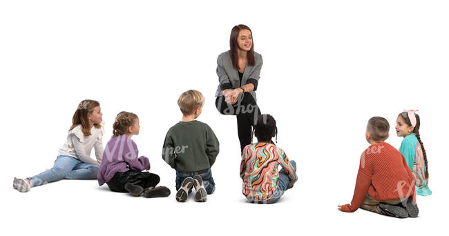 group of children stting on the ground and listening to their teacher