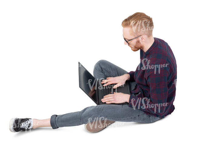 man sitting on the ground and working with a laptop