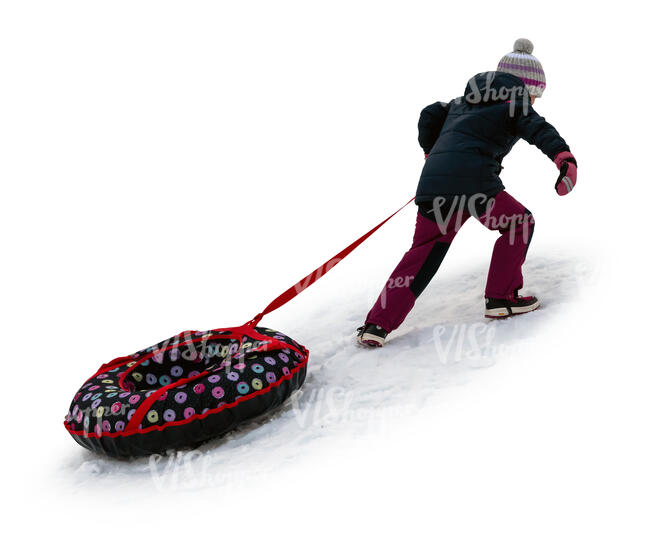 cut out little girl climbing up a snowy hill with her sledge