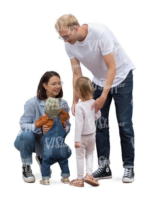 family with two little kids standing in the street