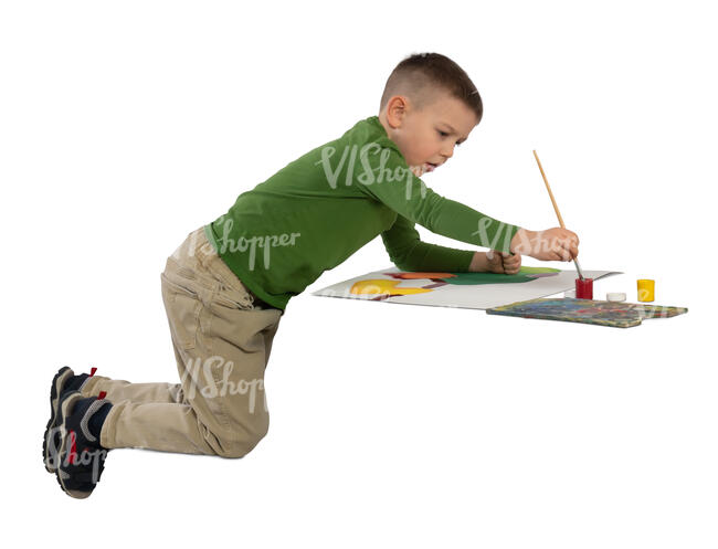 little boy sitting at a table and painting a picture 