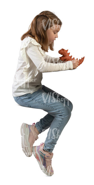 little girl sitting at a table and sculpting a dinosaur