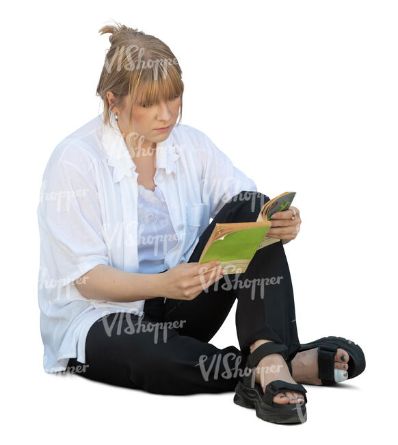 woman sitting on the ground and reading a book