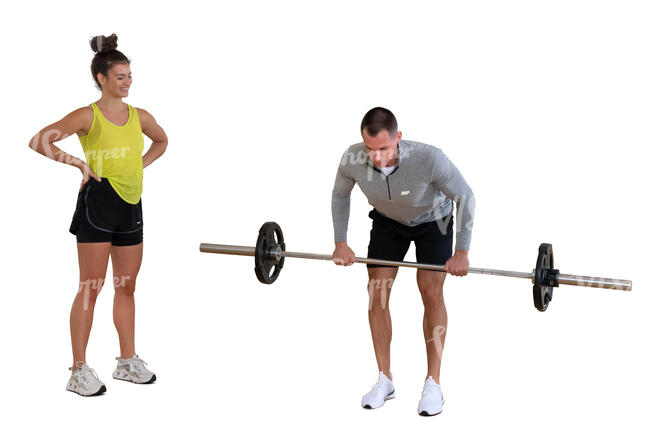 man lifting weights and woman standing by