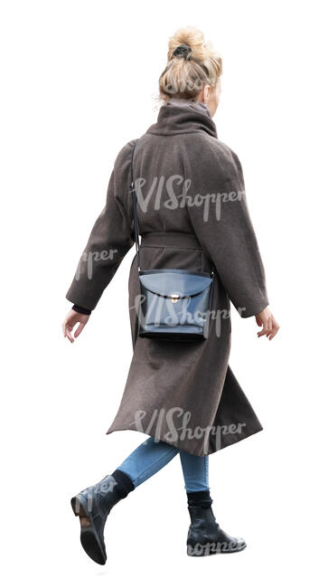 woman in a brown overcoat walking hastily