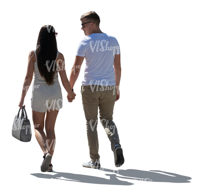 backlit couple walking hand in hand