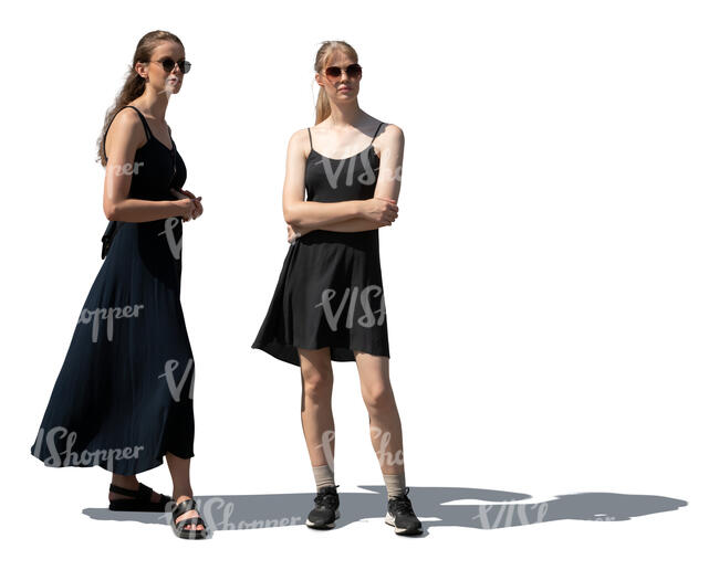 two women in black dresses standing and looking at smth