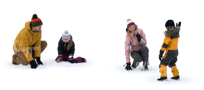 family playing with snow outside in winter