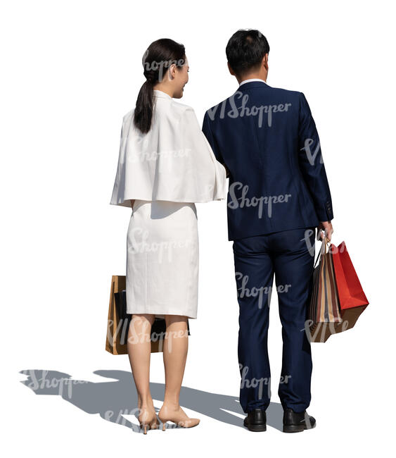 asian couple with shopping bags standing in front of the shop window