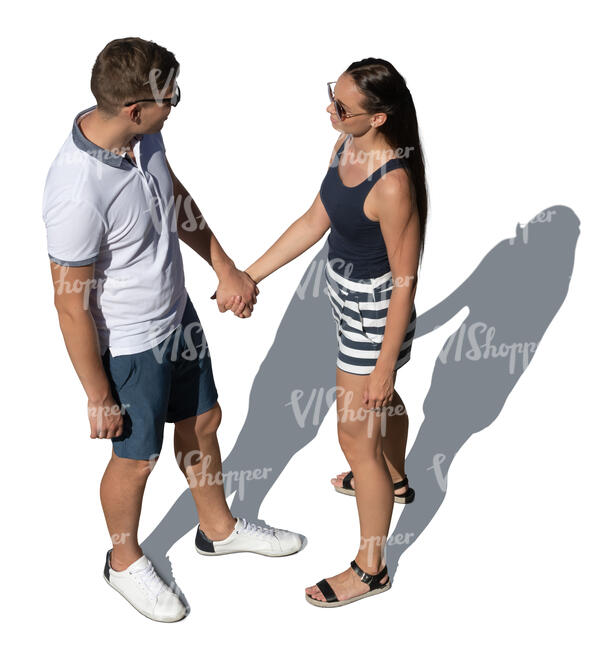 couple holding hands standing and looking at each other seen from above