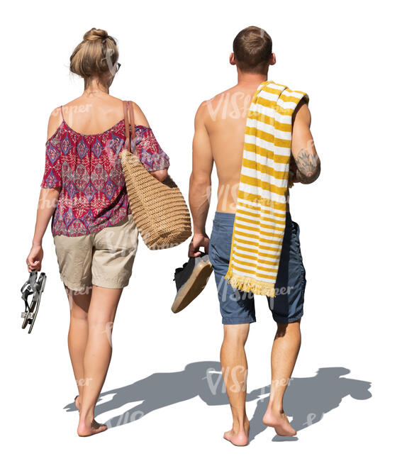 two people walking barefoot at the resort going swimming