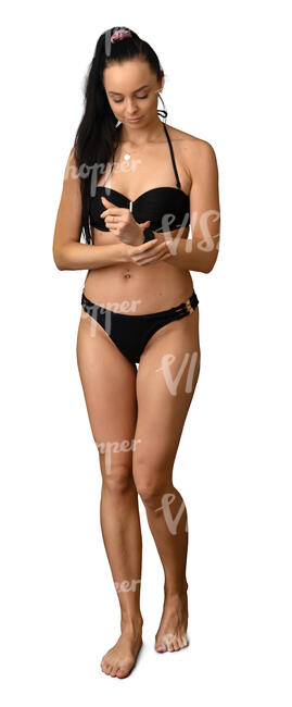 woman in a black bikini walking