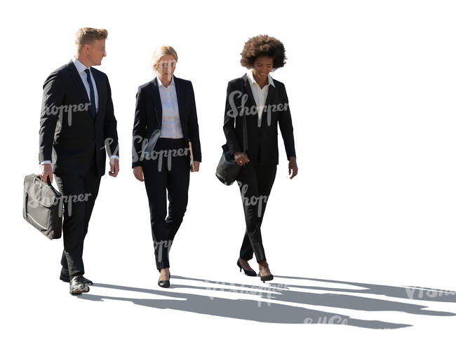 backlit group of office workers walking