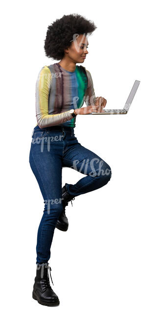 woman sitting at a counter high table on a barstool with a laptop