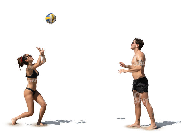 man and woman playing volleyball at the beach