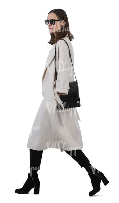 woman in a white overcoat walking