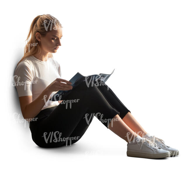 woman sitting by the window and reading a magazine