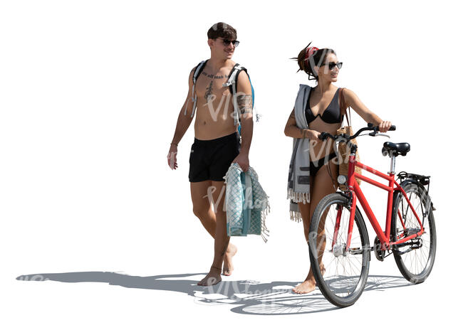 man and woman with a bike going to the beach