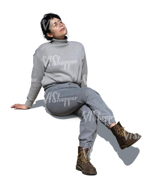 woman in grey outfit sitting end enjoying sun