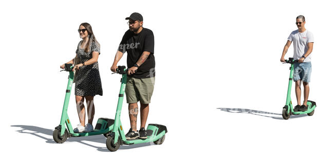 group of three people riding on electric scooters