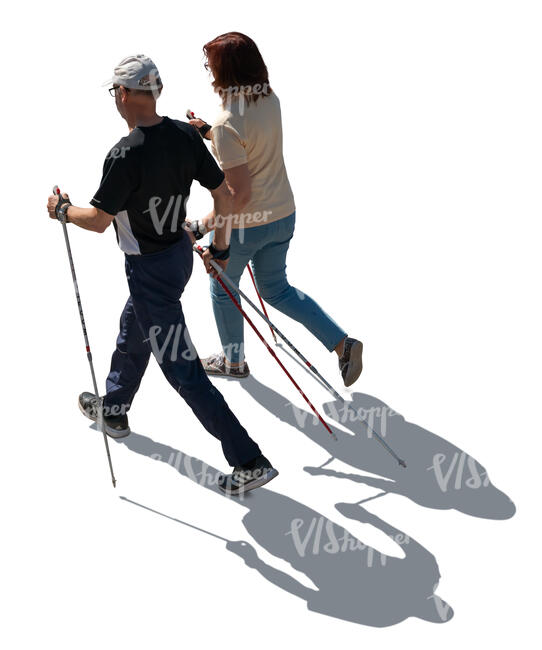 backlit elderly couple nordic walking